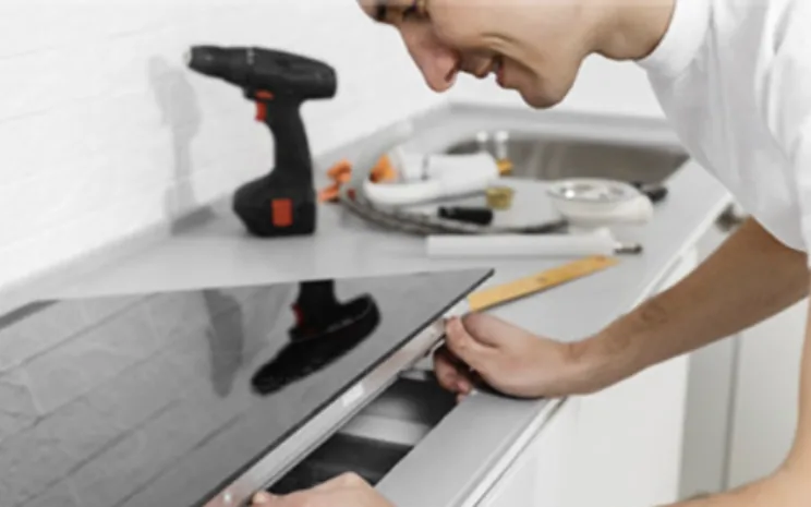 Engineer repairing a ceramic hob